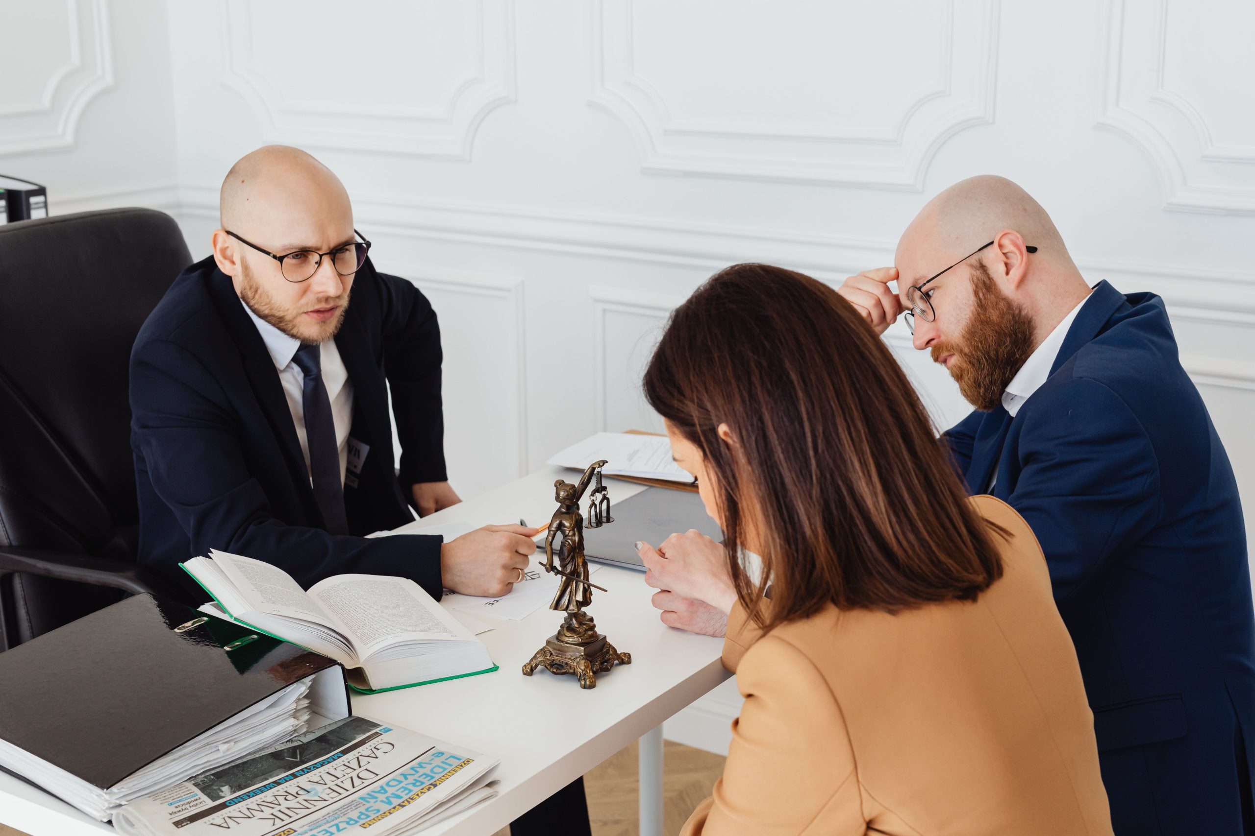 Lawyer consulting clients in a modern office about legal services and costs