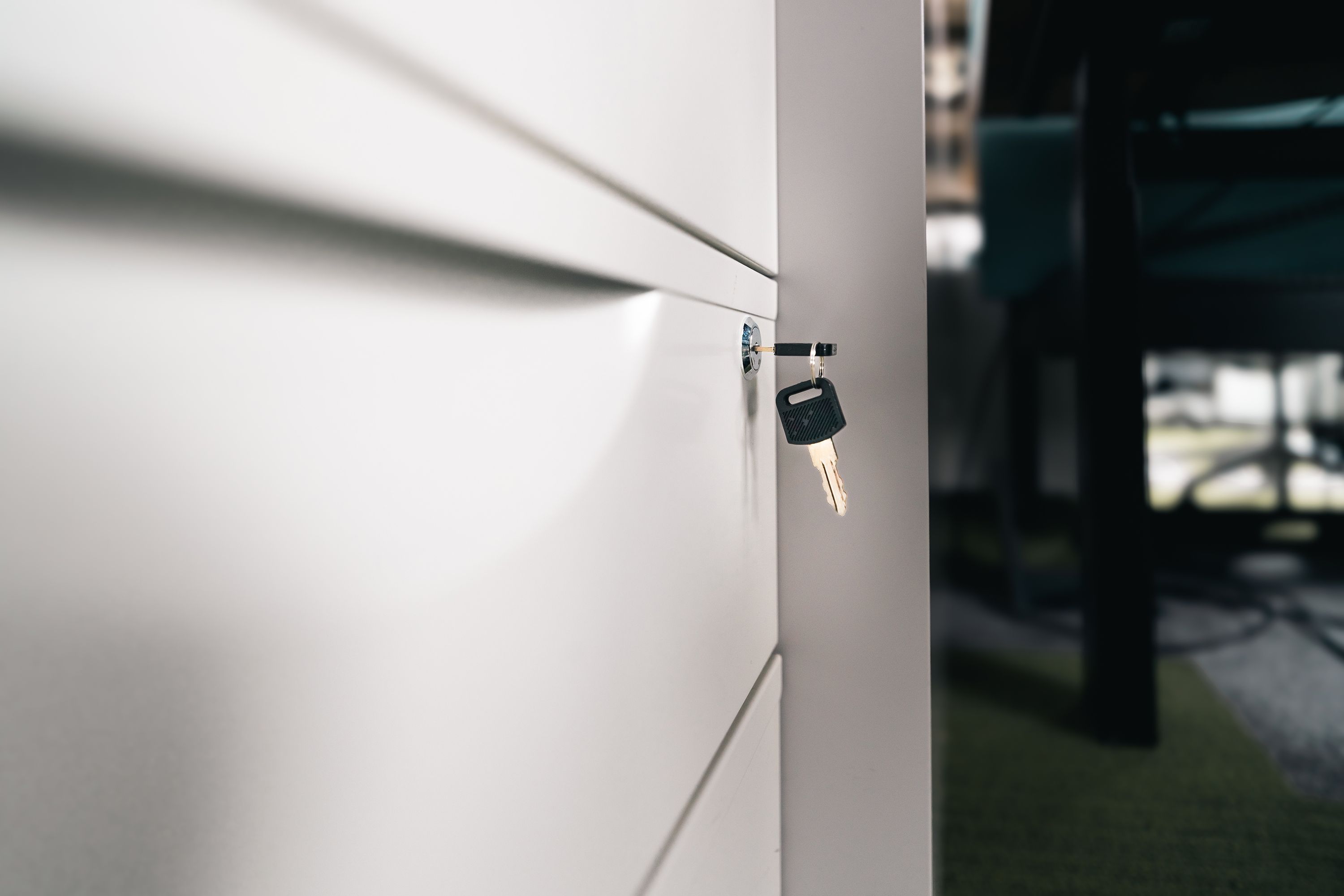 Key in a locked office drawer, symbolizing restricted access and secure information storage.